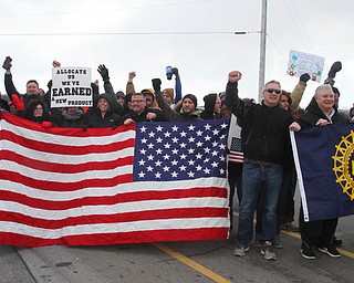 William D. Lewis The Vindicator   Workers and supporters block the road for a moment outside the GM plant 3-6-19