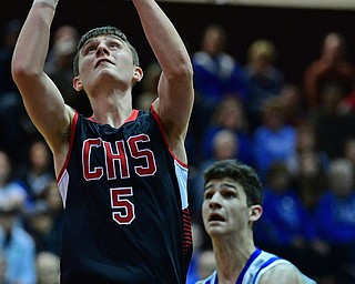 BOARDMAN, OHIO - MARCH 6, 2019: Canfield's Joe Bruno goes to the basket against Poland's Braeden O'Shaughnessy during the first half of their OHSAA Tournament game, Wednesday night at Boardman High School. DAVID DERMER | THE VINDICATOR