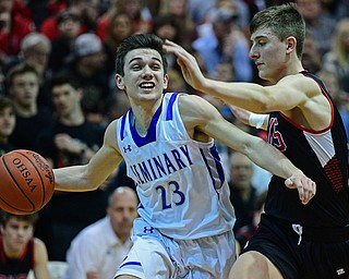 BOARDMAN, OHIO - MARCH 6, 2019: Poland's Michael Cougras drives on Canfield's Joe Bruno during the first half of their OHSAA Tournament game, Wednesday night at Boardman High School. DAVID DERMER | THE VINDICATOR