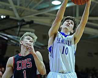 BOARDMAN, OHIO - MARCH 6, 2019: Poland's Daniel Kramer grabs a rebound away from Canfield's Aydin Hanousek during the first half of their OHSAA Tournament game, Wednesday night at Boardman High School. DAVID DERMER | THE VINDICATOR