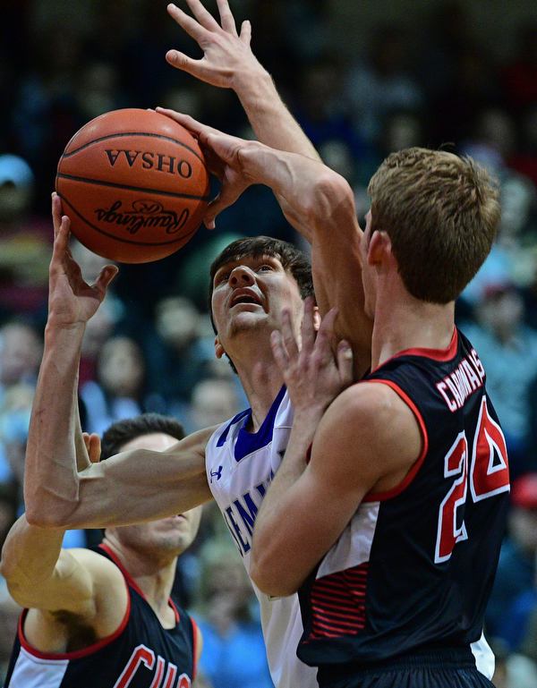 BOARDMAN, OHIO - MARCH 6, 2019: Poland's Daniel Kramer puts up a shot against Canfield's Kyle Gamble during the first half of their OHSAA Tournament game, Wednesday night at Boardman High School. DAVID DERMER | THE VINDICATOR