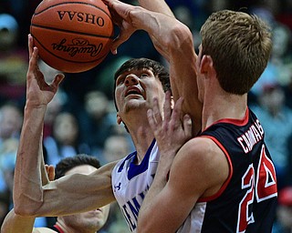 BOARDMAN, OHIO - MARCH 6, 2019: Poland's Daniel Kramer puts up a shot against Canfield's Kyle Gamble during the first half of their OHSAA Tournament game, Wednesday night at Boardman High School. DAVID DERMER | THE VINDICATOR