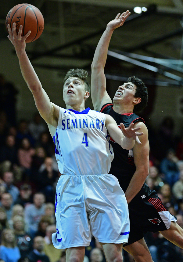 BOARDMAN, OHIO - MARCH 6, 2019: Poland's Jeff McAuley goes to the basket against Canfield's Conor Grogan during the first half of their OHSAA Tournament game, Wednesday night at Boardman High School. DAVID DERMER | THE VINDICATOR