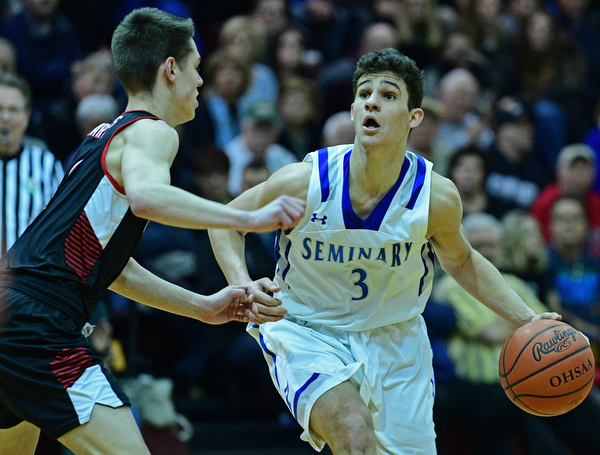BOARDMAN, OHIO - MARCH 6, 2019: Poland's Braeden O'Shaughnessy drives on Canfield's Aydin Hanousek during the second half of their OHSAA Tournament game, Wednesday night at Boardman High School. DAVID DERMER | THE VINDICATOR