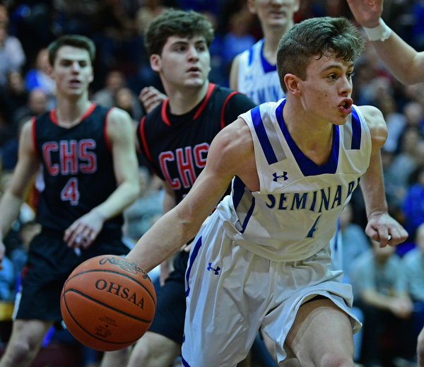 BOARDMAN, OHIO - MARCH 6, 2019: Poland's Jeff McAuley drives down the lane during the second half of their OHSAA Tournament game, Wednesday night at Boardman High School. DAVID DERMER | THE VINDICATOR..Canfield's Luke Pallante and Jake Kowal pictured.