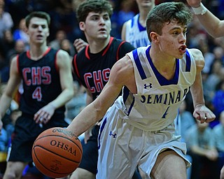 BOARDMAN, OHIO - MARCH 6, 2019: Poland's Jeff McAuley drives down the lane during the second half of their OHSAA Tournament game, Wednesday night at Boardman High School. DAVID DERMER | THE VINDICATOR..Canfield's Luke Pallante and Jake Kowal pictured.