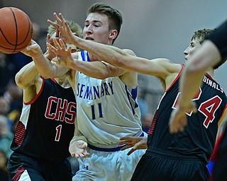 BOARDMAN, OHIO - MARCH 6, 2019: Poland's Collin Todd passes the ball while being pressured by Canfield's Kyle Gamble, right, and Aydin Hanousek during the second half of their OHSAA Tournament game, Wednesday night at Boardman High School. DAVID DERMER | THE VINDICATOR.