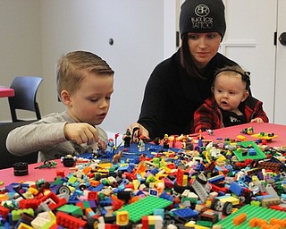 Neighbors | Abby Slanker.Beckett Landess got some help building with Legos from his mom, Sierra, and sister, Evelynn, at Canfield library’s Lego my Library on Feb. 2.
