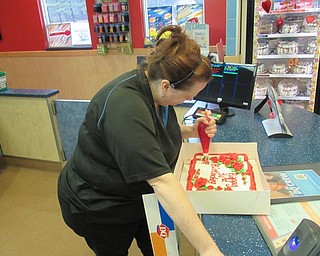 Neighbors | Jessica Harker.Dairy Queen store manager Amy Zacardi iced a cake for a customer on Feb. 12 at the Austintown Dairy Queen that recently received the annual PRIDE award for the ninth year in a row.