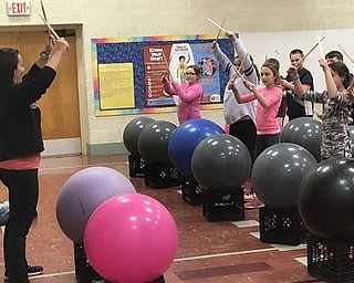 Neighbors | Jessica Harker.Melony Angiuli guided students as they kept the rhythm to the music using exercise balls, crates and drumsticks during Stadium Drive Elementary School's Drums Alive after school class Feb. 26.
