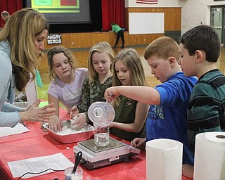 Neighbors | Abby Slanker.With the help of parent volunteer Michelle Sebastiani, C.H. Campbell Elementary School third-grade students experimented with instant snow, helping to measure and weigh the materials during the school’s annual STEM Week on Feb. 28..