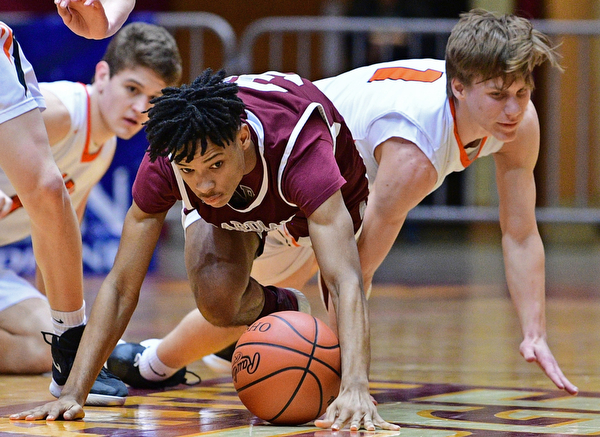 CANTON, OHIO - MARCH 7, 2019: Boardman's Dacone Martin, left, and Green's Shea Simmer crawl for a loose ball during the first half of their OHSAA Tournament game, Thursday night at the Canton Civic Center. DAVID DERMER | THE VINDICATOR