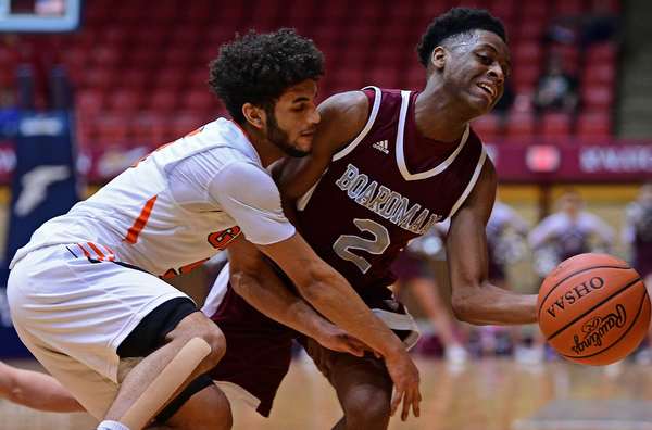 CANTON, OHIO - MARCH 7, 2019: Boardman's Che Trevena collides with Green's Kaleb Martinduring the first half of their OHSAA Tournament game, Thursday night at the Canton Civic Center. DAVID DERMER | THE VINDICATOR