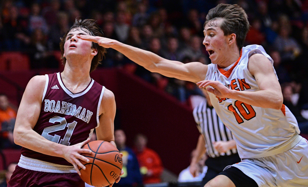 CANTON, OHIO - MARCH 7, 2019: Boardman's Cam Creps goes to the basket while being chased by Green's Ryan Smith during the first half of their OHSAA Tournament game, Thursday night at the Canton Civic Center. DAVID DERMER | THE VINDICATOR