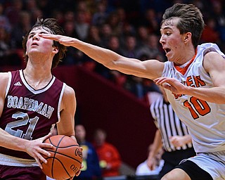 CANTON, OHIO - MARCH 7, 2019: Boardman's Cam Creps goes to the basket while being chased by Green's Ryan Smith during the first half of their OHSAA Tournament game, Thursday night at the Canton Civic Center. DAVID DERMER | THE VINDICATOR