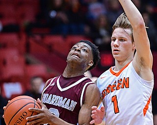 CANTON, OHIO - MARCH 7, 2019: Boardman's Che Trevena drives on Green's Shea Simmer during the first half of their OHSAA Tournament game, Thursday night at the Canton Civic Center. DAVID DERMER | THE VINDICATOR