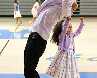 Jose Feliciano dances with his daughter Alexis Feliciano, 6, both of Youngstown, during the Youngstown City School District father-daughter dance at East High School on Friday night. EMILY MATTHEWS | THE VINDICATOR