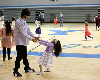 Jose Feliciano dances with his daughter Alexis Feliciano, 6, both of Youngstown, during the Youngstown City School District father-daughter dance at East High School on Friday night. EMILY MATTHEWS | THE VINDICATOR