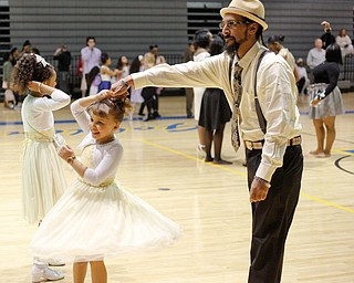 James Bevely dances with his daughter Ja'lisa Bevely, 7, both of Youngstown, during the Youngstown City School District father-daughter dance at East High School on Friday night. EMILY MATTHEWS | THE VINDICATOR