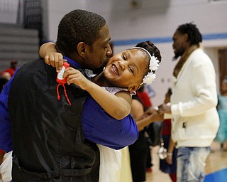 Faybeon Stewart, of Youngstown, kisses his daughter Makyla Stewart, 5, on the cheek during the Youngstown City School District father-daughter dance at East High School on Friday night. EMILY MATTHEWS | THE VINDICATOR