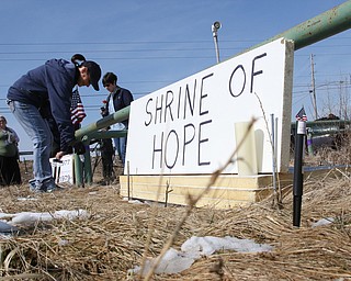  ROBERT K.YOSAY  | THE VINDICATOR..Werner Lange, the guy who held the 43 day vigil outside the plant, is having an outdoor tribute to women workers and a Òprotest against the gross injustice of idling of this plant.Ó..Vickie Raymond plasces a flower and a light for the memorial