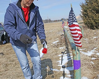  ROBERT K.YOSAY  | THE VINDICATOR..Werner Lange, the guy who held the 43 day vigil outside the plant, is having an outdoor tribute to women workers and a Òprotest against the gross injustice of idling of this plant.Ó..Vickie Raymond plasces a flower and a light for the memorial