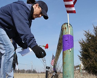  ROBERT K.YOSAY  | THE VINDICATOR..Werner Lange, the guy who held the 43 day vigil outside the plant, is having an outdoor tribute to women workers and a Òprotest against the gross injustice of idling of this plant.Ó..Vickie Raymond plasces a flower and a light for the memorial