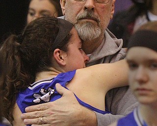 William D. Lewis The Vindicator  Poland's Jackie Grisdale(21) gets a hig from her father Ken Grisdale after Lady Bulldogs lost to Akron SVSM at Barberton 3-8-19. Ken is Poland Boys Basketball coach.