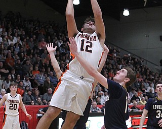 Shane Eynon (12) of Springfield goes up for a shot while being defended by Jake Rotz of Lowellville during Friday nights district championship game at Struthers High School.  Dustin Livesay  |  The Vindicator  3/8/19  Struthers