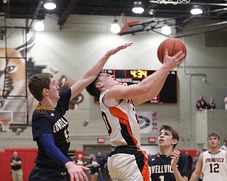 Beau Brungard (20) of Springfield gets hit in the head by Jake Rotz (15) of Lowellville during Friday nights district championship game at Struthers High School.  Dustin Livesay  |  The Vindicator  3/8/19  Struthers