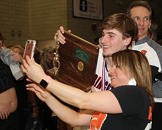 Springfield’s Clay Medvec takes a picture with his mom Angie Medvec with the District Championship trophy after they defeated Lowellville at the Struthers Fieldhouse on Friday night.  Dustin Livesay  |  The Vindicator  3/8/19  Struthers