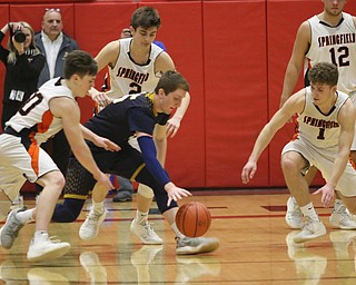 Jake Rotz (middle) of Lowellville fights for a loose ball with Springfieldâ€™s Beau Brungard (left) and Evan Ohlin (1) during Friday nights district championship game at Struthers High School.  Dustin Livesay  |  The Vindicator  3/8/19  Struthers