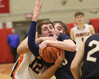 Springfield’s Shane Eynon (12) and Lowellvilles Jake Rotz (15) fight for the ball in the fourth quarter of Friday nights district championship game at Struthers High School.  Dustin Livesay  |  The Vindicator  3/8/19  Struthers