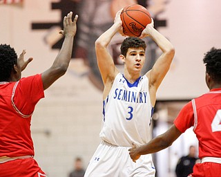 Poland's Braeden O'Shaughnessy looks to pass the ball while Chaney's Jamison Tubbs (1) and Ryan Clark (4) try to block him during their game at Boardman High School on Saturday. EMILY MATTHEWS | THE VINDICATOR