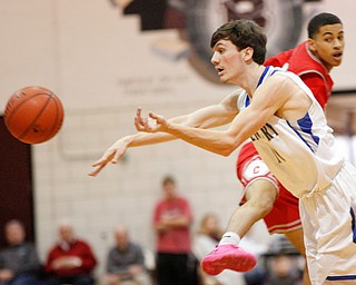 Poland's Daniel Kramer passes the ball while Chaney's Sharrod Taylor tries to block him during their game at Boardman High School on Saturday. EMILY MATTHEWS | THE VINDICATOR