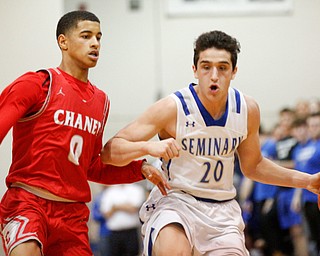 Poland's Adam Kassem drives the ball while Chaney's Sharrod Taylor tries to block him during their game at Boardman High School on Saturday. EMILY MATTHEWS | THE VINDICATOR