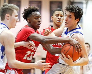 Poland's Adam Kassem, right, and Chaney's William Brown (23) battle for the ball while Poland's Collin Toss, left, and Chaney's Sharrod Taylor, second from right, stand by during their game at Boardman High School on Saturday. EMILY MATTHEWS | THE VINDICATOR