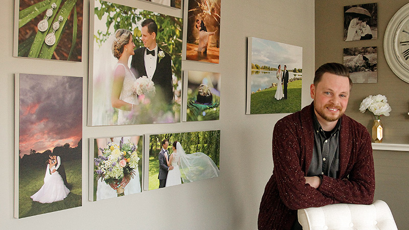 ROBERT K. YOSAY | THE VINDICATOR
Pictured is Josh Trolio, Pixel Pop Photography co-owner, standing in front of some of his work at Pixel Pop Photography in Boardman.
