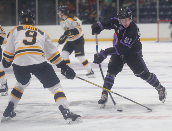 The Phantoms' Connor MacEachern prepares to pass the puck while the Gamblers' Tyler Spott tries to block him during their game in Covelli Centre on Sunday. EMILY MATTHEWS | THE VINDICATOR