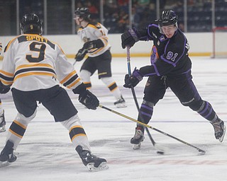 The Phantoms' Connor MacEachern prepares to pass the puck while the Gamblers' Tyler Spott tries to block him during their game in Covelli Centre on Sunday. EMILY MATTHEWS | THE VINDICATOR