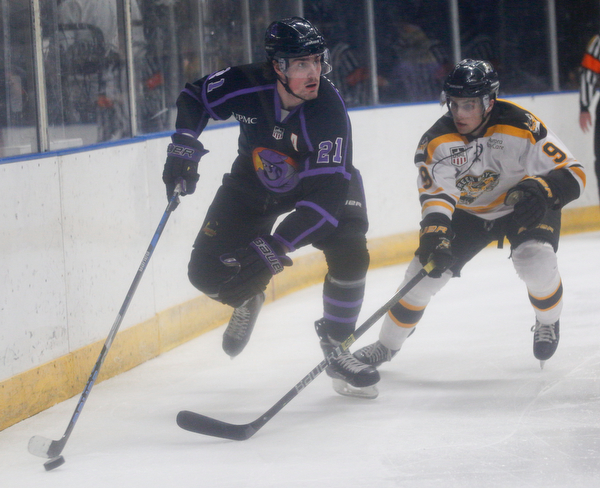 The Phantoms' Brett Murray takes the puck behind the net as he tries to keep it from the Gamblers' Tyler Spott during their game in Covelli Centre on Sunday. EMILY MATTHEWS | THE VINDICATOR