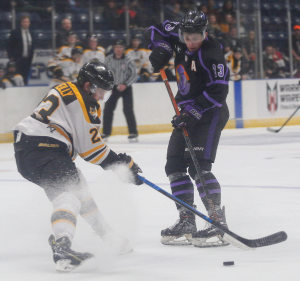The Phantoms' Gianfranco Cassaro and the Gamblers' Ryan O'Reilly battle for the puck during their game in Covelli Centre on Sunday. EMILY MATTHEWS | THE VINDICATOR