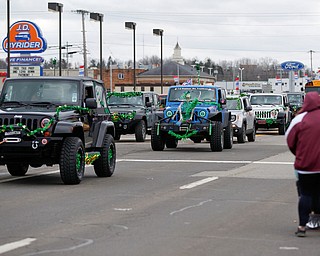 Jeeps decked out in St. Patrick's Day decorations drive down Market Street during the Mahoning Valley St. Patrick's Day Parade in Boardman on Sunday afternoon. EMILY MATTHEWS | THE VINDICATOR