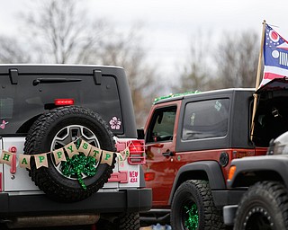 Jeeps decked out in St. Patrick's Day decorations drive down Market Street during the Mahoning Valley St. Patrick's Day Parade in Boardman on Sunday afternoon. EMILY MATTHEWS | THE VINDICATOR