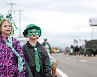 Siblings Nora, 6, and Liam McMasters, 4, watch the Mahoning Valley St. Patrick's Day Parade in Boardman on Sunday afternoon. EMILY MATTHEWS | THE VINDICATOR