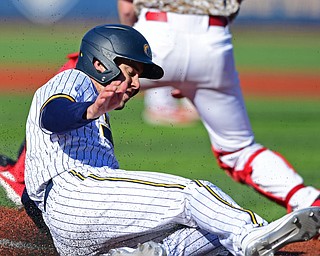 KENT, OHIO - MARCH 12, 2019: Kent State's Ben Carew slides across home plate to score a run during the first inning of their game, Tuesday afternoon at Kent State. Kent State won 10-5. DAVID DERMER | THE VINDICATOR