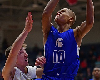 CANTON, OHIO - MARCH 12, 2019: Richmond Heights' Jamarr Talbert Jr. goes to the basket against Bristol's Zack Stern during the second half of their game, Tuesday night at the Canton. Richmond Heights won 66-34. DAVID DERMER | THE VINDICATOR