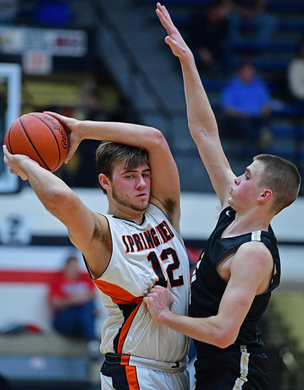CANTON, OHIO - MARCH 12, 2019: Springfield's Shane Eynon looks to pass while being pressured by South Central's David Lamoreaux during the second half of their game, Tuesday night at the Canton Fieldhouse. DAVID DERMER | THE VINDICATOR