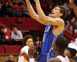 William D. Lewis The Vindicator Poland's Daniel Kramer(10) shoots past Buchtel's Chris Livingston (24).