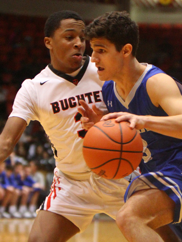 William D. Leiws The vindicator  Poland's Braeden O' Shaughnessy (3) drives around Buchtel's Martavian Johnson(3).